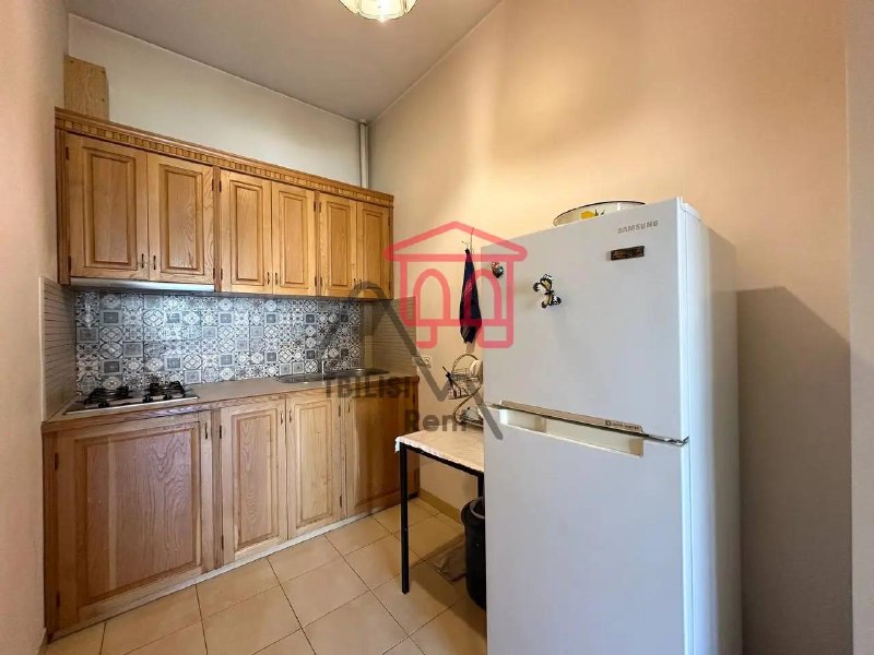 A one-bedroom apartment in the Vake district is for sale. It features bamboo parquet floors and a spacious balcony with a beautiful view of the Vera River Valley. The kitchen is separate but can be combined with the main room. A parking space is also available for purchase. — фото 4