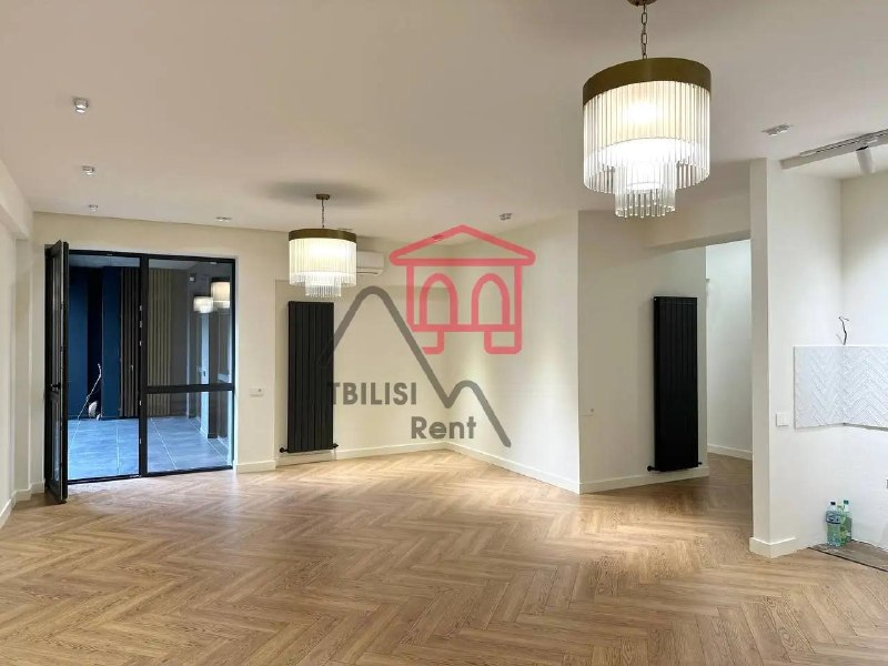 A spacious, newly renovated, unfurnished apartment in a new building on the Nutsubidze Plateau is for sale. It features a living room, two bedrooms, a walk-in closet, two bathrooms, and a spacious balcony. It features German laminate flooring and Italian heating. — фото 1