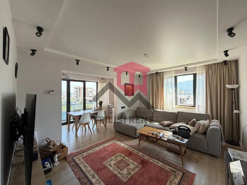 A bright corner apartment is for sale in the Saburtalo District, featuring a newly renovated space, furniture, and appliances, as well as an excellent view. The apartment has a separate kitchen, a loggia, 2 bedrooms, a walk-in closet, an entryway, a separate bathroom, and a bathroom. The materials, furniture, and appliances are of high quality. — фото 1